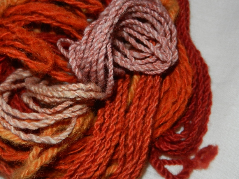 Orange and red silk, cotton, and wool yarn.