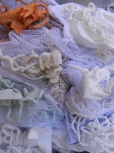 Pile of white and off-white yarns and cottons in slightly varying shades.