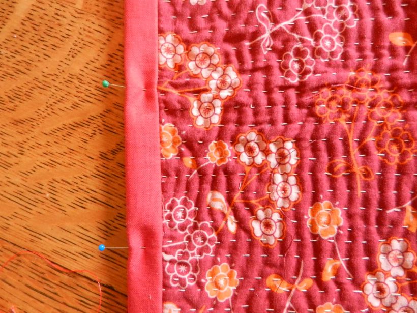 Red-flowered Sashiko cloth and pinned binding